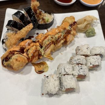 Sushi UNI - Left to right - Rock N Roll, Dino roll and Philadelphia roll. - Sushi Bars Near Me - Lenexa, Kansas Sushi UNI - Left to right - Rock N Roll, Dino roll and Philadelphia roll. - Sushi Bars Near Me - Lenexa, Kansas