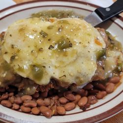 Western View Diner & Steakhouse - Chicken fried steak over fried potatoes , smothered in green chili to eggs over Medium, Pinto beans on the side