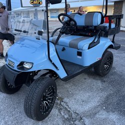 2 seater Light blue golf cart.