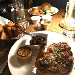 Crispy chicken, with Patatas Brava with smoked pineapple salsa; Burger w/bacon or a fried egg, cheese and pickled cucumbers. Crispy chicken, with Patatas Brava with smoked pineapple salsa; Burger w/bacon or a fried egg, cheese and pickled cucumbers.