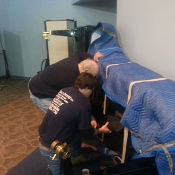 WP Broms - Our piano experts wrapping and moving a beautiful grand piano - Movers Near Me - Schaumburg, Illinois WP Broms - Our piano experts wrapping and moving a beautiful grand piano - Movers Near Me - Schaumburg, Illinois