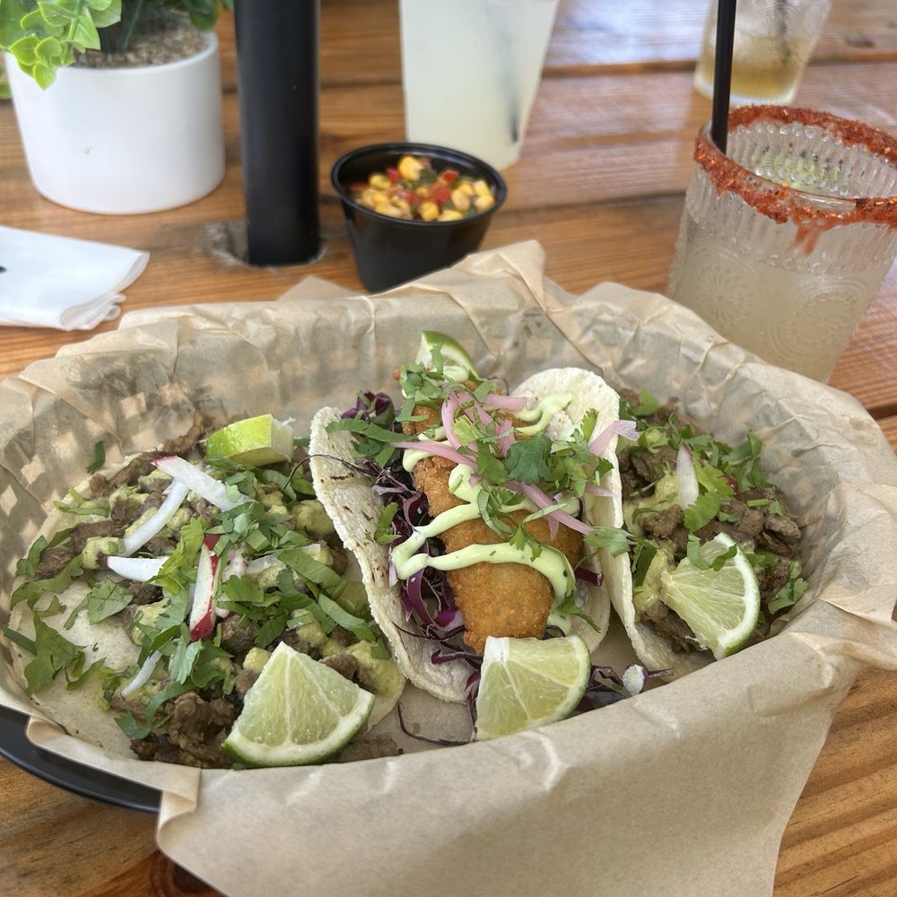 Botanico Tacos & Tequila - Carne asada taco, fish taco. Skinny margarita in a small cup. The larger drink with the straw is my son's lemonade. - Bars Near Me - Mount Dora, Florida