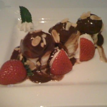 Cadot Restaurant - Profiteroles with Guanduja Chocolate Sauce and Fresh Strawberries - French Near Me - Dallas, Texas Cadot Restaurant - Profiteroles with Guanduja Chocolate Sauce and Fresh Strawberries - French Near Me - Dallas, Texas