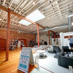 The Sinclair on G Street - Upstairs open floor plan with bounce house, soft play area, bar, and seating.