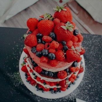 The Gourmet Cupcake Shoppe - a cake with strawberries and blueberries - Bakeries Near Me - Midland, Michigan