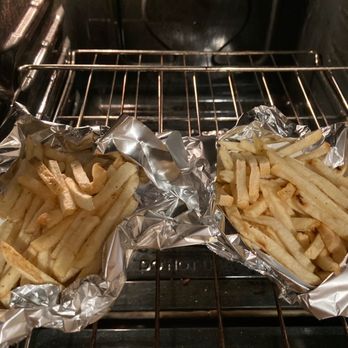 In-N-Out Burger - Fries.  The left fries are supposed to be well done. They were even packed in a separate bag. - Burgers Near Me - Long Beach, California