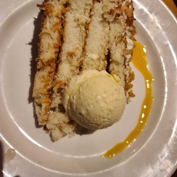 J Gilbert's - Toasted coconut cake, pineapple ice cream, and a passion fruit reduction - Seafood Near Me - Des Pers, Missouri J Gilbert's - Toasted coconut cake, pineapple ice cream, and a passion fruit reduction - Seafood Near Me - Des Pers, Missouri
