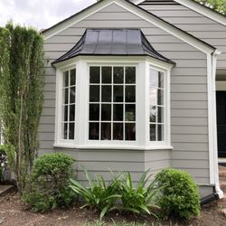Beautiful custom cuts for the curved bay roof. Angled corner cuts under the bay window-- very detailed work.