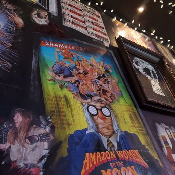 Holy Diver - a bunch of movie posters on a wall - Bars Near Me - London, Ontario