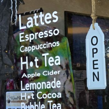 Kind Brew Coffee - Window advertisement of their products and the OPEN sign. - Coffee & Tea Near Me Kind Brew Coffee - Window advertisement of their products and the OPEN sign. - Coffee & Tea Near Me