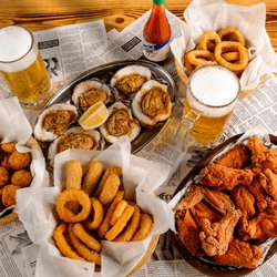 Red Crab Juicy Seafood - Seafood night done right--Cajun oysters, crispy wings, onion rings and golden fried bites served with ice-cold beer.