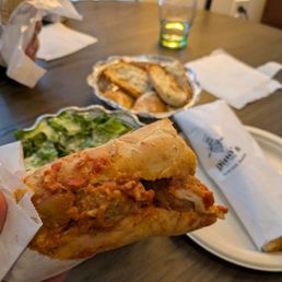 Meatball sub (Caesar salad and garlic bread in the back)