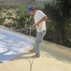 Above & Beyond Roofing Systems - Vince, the owner, coating a new urethane foam roof installation in Bighorn Country Club, Palm Desert.
