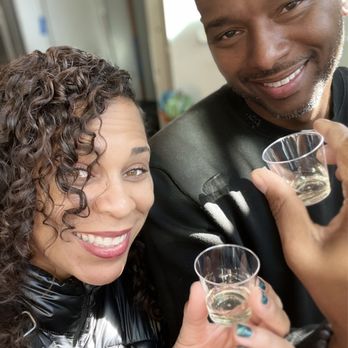 Thrasher's Rum - a man and a woman holding glasses - Distilleries Near Me - Washington, DC, District of Columbia