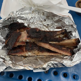 Bright Light Catering - a plate of ribs wrapped in tin foil - Food Trucks Near Me Bright Light Catering - a plate of ribs wrapped in tin foil - Food Trucks Near Me