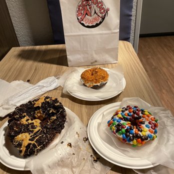 Voodoo Doughnut - two plates of doughnuts and a bag of candy - Donuts Near Me - Portland, Oregon Voodoo Doughnut - two plates of doughnuts and a bag of candy - Donuts Near Me - Portland, Oregon
