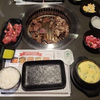 E.M. Bop - Thin sliced brisket (right side grill), EM bop short rib cuts (left side grill), seasoned short rib cuts (left) & egg souffle (right) - Korean Near Me - Duluth, Georgia