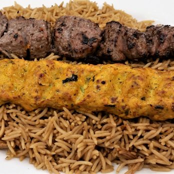 Mazadar Mediterranean Kitchen - Lamb shish kabob above a chicken kofta on basmati rice. - Mediterranean Near Me - Albany, New York