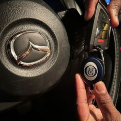 Testing a programmed Mazda key fob inside the vehicle.