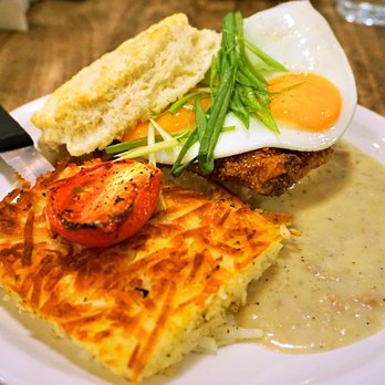Jam Cafe on Beatty - The Gravy Coop: buttermilk biscuit topped with fried chicken, two sunny eggs, green onions, sausage gravy. Served with hash browns ($18). - Breakfast & Brunch Near Me - Vancouver, British Columbia