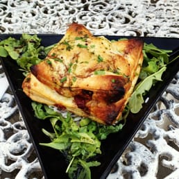 Spinach, olive and mozzarella puff pastry parcel served on a bed of lemon rice with balsamic and basil oil dressed rocket leaves Spinach, olive and mozzarella puff pastry parcel served on a bed of lemon rice with balsamic and basil oil dressed rocket leaves