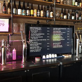 TapHouse 61 - a bar with a variety of bottles of alcohol - Beer Bar Near Me - Saint Petersburg, Florida