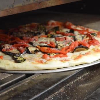 Pizzeria Dei Sassi - a pizza cooking in an oven - Pizza Near Me - Mississauga, Ontario Pizzeria Dei Sassi - a pizza cooking in an oven - Pizza Near Me - Mississauga, Ontario