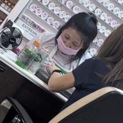 Luxury SNS Nails - In front of her client is 2 shot glasses...