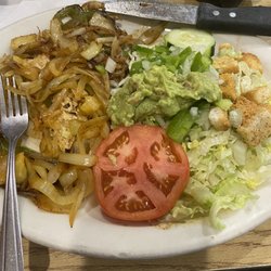 Fiesta Mexico Restaurant - Grilled chicken with peppers and onions and a few pineapple pieces and salad with a little bit of guacamole.