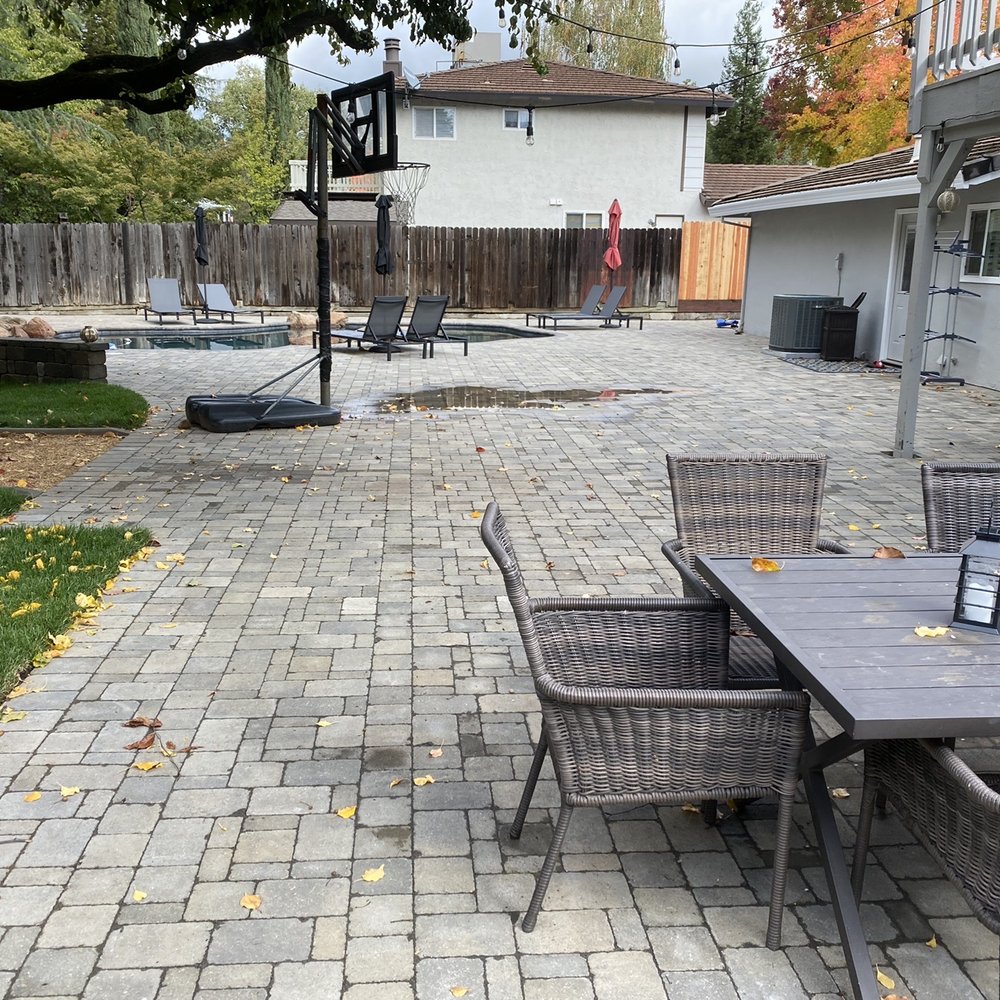 LR Landscaping & Pavers - a patio with a table and chairs - Landscaping Near Me LR Landscaping & Pavers - a patio with a table and chairs - Landscaping Near Me