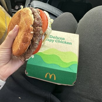 McDonald's - a person holding a sandwich in their lap - Burgers Near Me - Wichita, Kansas McDonald's - a person holding a sandwich in their lap - Burgers Near Me - Wichita, Kansas