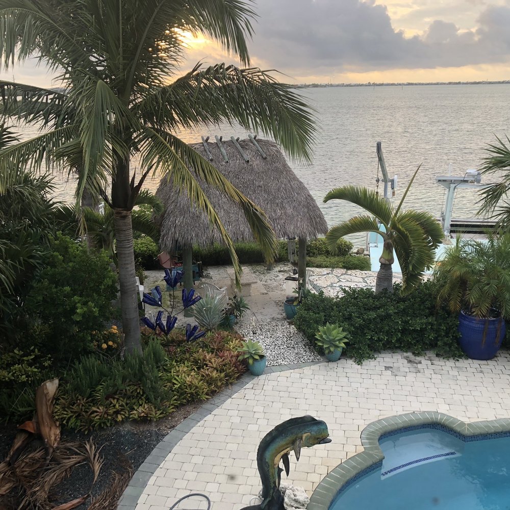 Mama's Garden Center - Tiki hut with Mam'a bottle palm and creature palm tree - Landscaping Near Me - Key West, Florida