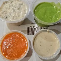 Taheni Cafe & Grill - Small side of Baba Ganoush, Cilantro Avacado sauce, Tahini sauce, and Shattah hot sauce. All sauces are delicious.