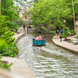 Acenar Mexican Restaurant - The view of the San Antonio River from our Riverwalk patio as a River Barge sails through.