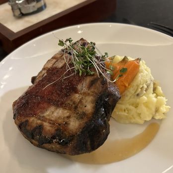 Blue Flame - Brined pork chop with garlic mashed. - Bars Near Me - Daytona Beach, Florida