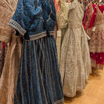 Mohini - Traditional Indian dresses - Collection of traditional Indian dresses featuring detailed embroidery, beadwork, and embellishments, displayed on hangers in a retail store. - Women's Clothing Near Me - Dulles, Virginia