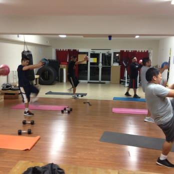 FitNow - Bootcamp group exercise, total body session. Working the shoulders with the medicine ball and core as they add the high knees. - Trainers Near Me - Fairfield, California FitNow - Bootcamp group exercise, total body session. Working the shoulders with the medicine ball and core as they add the high knees. - Trainers Near Me - Fairfield, California