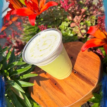 Erista Coffee - a drink in a plastic cup on a wooden stand - Coffee & Tea Near Me - Poulsbo, Washington