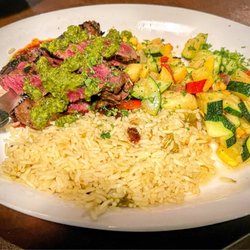 Saguaro Corners Restaurant & Bar - Marinated skirt steak with two different mystery sauce above and below.  The side is green Chile rice and a veggie medley.  Great dish!