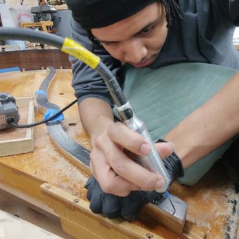 Stellar Piano Service - Wesley drilling holes in the bridge of a piano. - Piano Services Near Me - Los Angeles, California Stellar Piano Service - Wesley drilling holes in the bridge of a piano. - Piano Services Near Me - Los Angeles, California