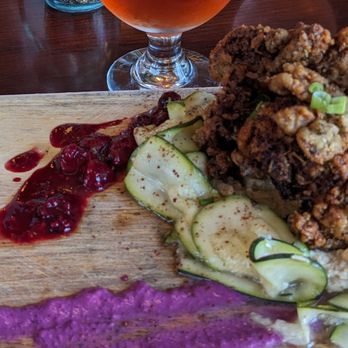 The Norwegian - Fried Oyster Mushrooms with blueberry tahini and tamarind berries on a bed of hummus and marinated zucchini. - Scandinavian Near Me - Rockford, Illinois