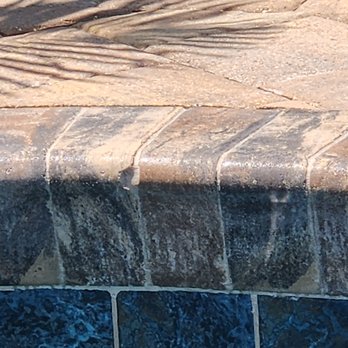 L&R Construction Pool & Concrete - chipped coping throughout. sealer stuck on grout lines - cannot get off - Pool & Hot Tub Service Near Me