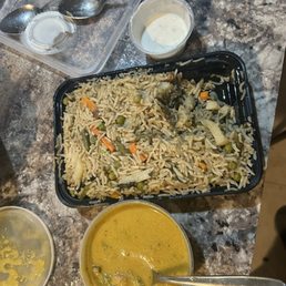 Veg biryanis kurma and raita