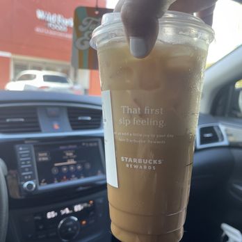 STARBUCKS - a hand holding a cup of iced coffee - Coffee & Tea Near Me - Coral Gables, Florida STARBUCKS - a hand holding a cup of iced coffee - Coffee & Tea Near Me - Coral Gables, Florida