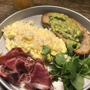 Granja Petitbo - Scrambled eggs with Parmesan cheese on top and avocado toast and iberico ham on the side. - Breakfast & Brunch Near Me - Barcelona, B