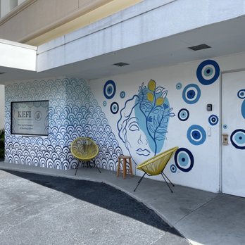 Kefi Streetside Cafe - a blue and white mural on the side of a building - Coffee & Tea Near Me - Bradenton, Florida