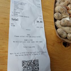 Five Guys - In Euros ($1.15) and the signature peanuts, bulk peanut bags on the floor.