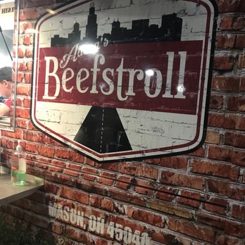 Adena's Beefstroll - a man standing in front of a brick wall - Food Trucks Near Me