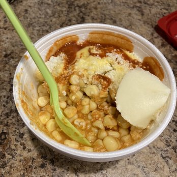 La Michoacana - Yellow corn!! :( - A disposable cup contains Mexican street corn with mayonnaise, cheese, and a lime wedge, placed on a granite countertop. - Ice Cream & Frozen Yogurt Near Me - Mesa, Arizona