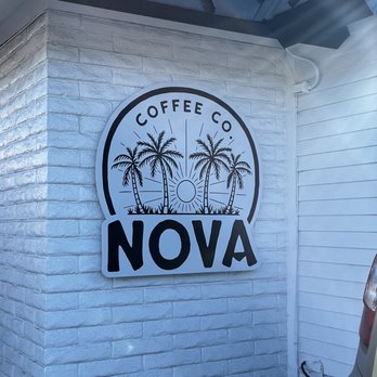 Nova Coffee - a white brick building with a black and white logo - Coffee & Tea Near Me - Arroyo Grande, California